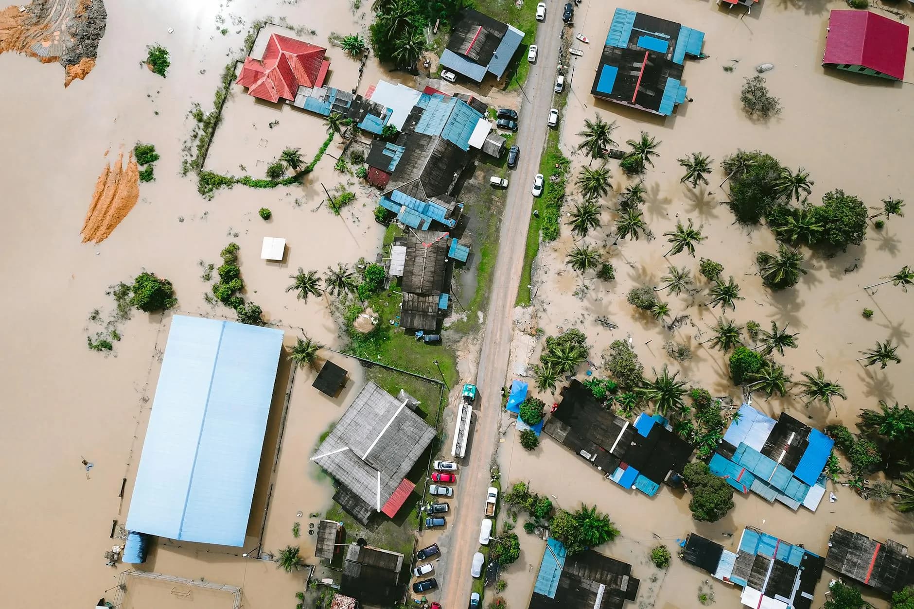 Drone footage shows submerged residential areas and damaged buildings in Kijal, Malaysia, due to severe flooding.