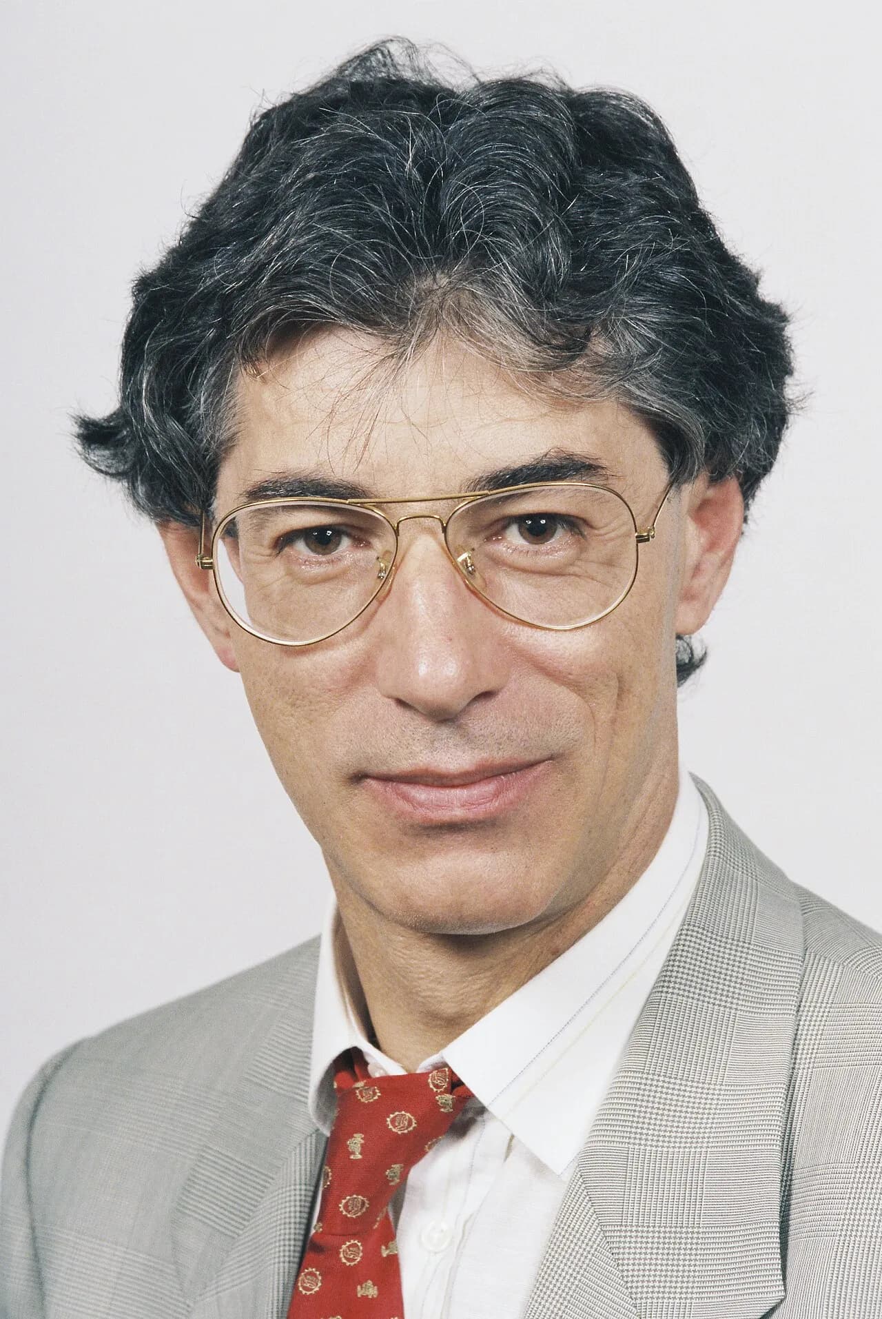 A formal portrait of Umberto Bossi, a former European Parliament member, captured in 1994.