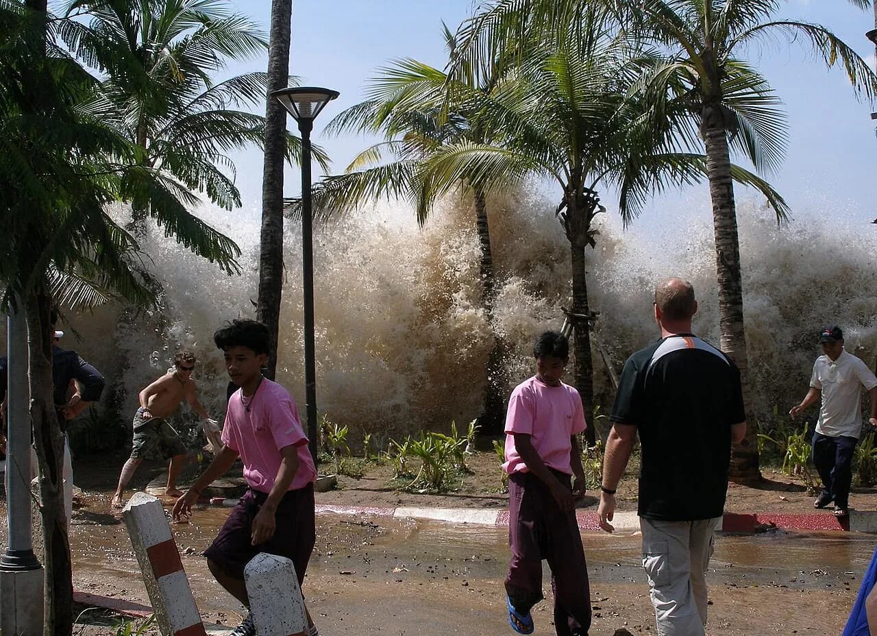 A photograph capturing the aftermath of the 2004 tsunami in Ao Nang, Krabi Province, Thailand.