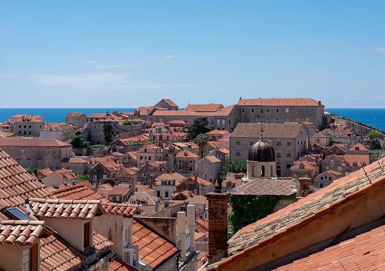 A detailed view of the old town roofs in Dubrovnik, showcasing the iconic Franciscan Church and Monastery tower.