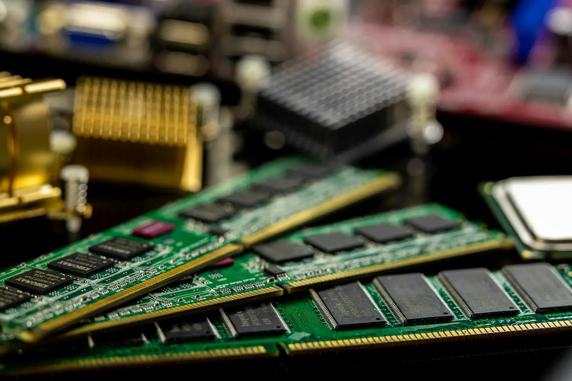 Detailed shot of RAM sticks and microprocessors arranged on a motherboard, highlighting the complexity of computer hardware.