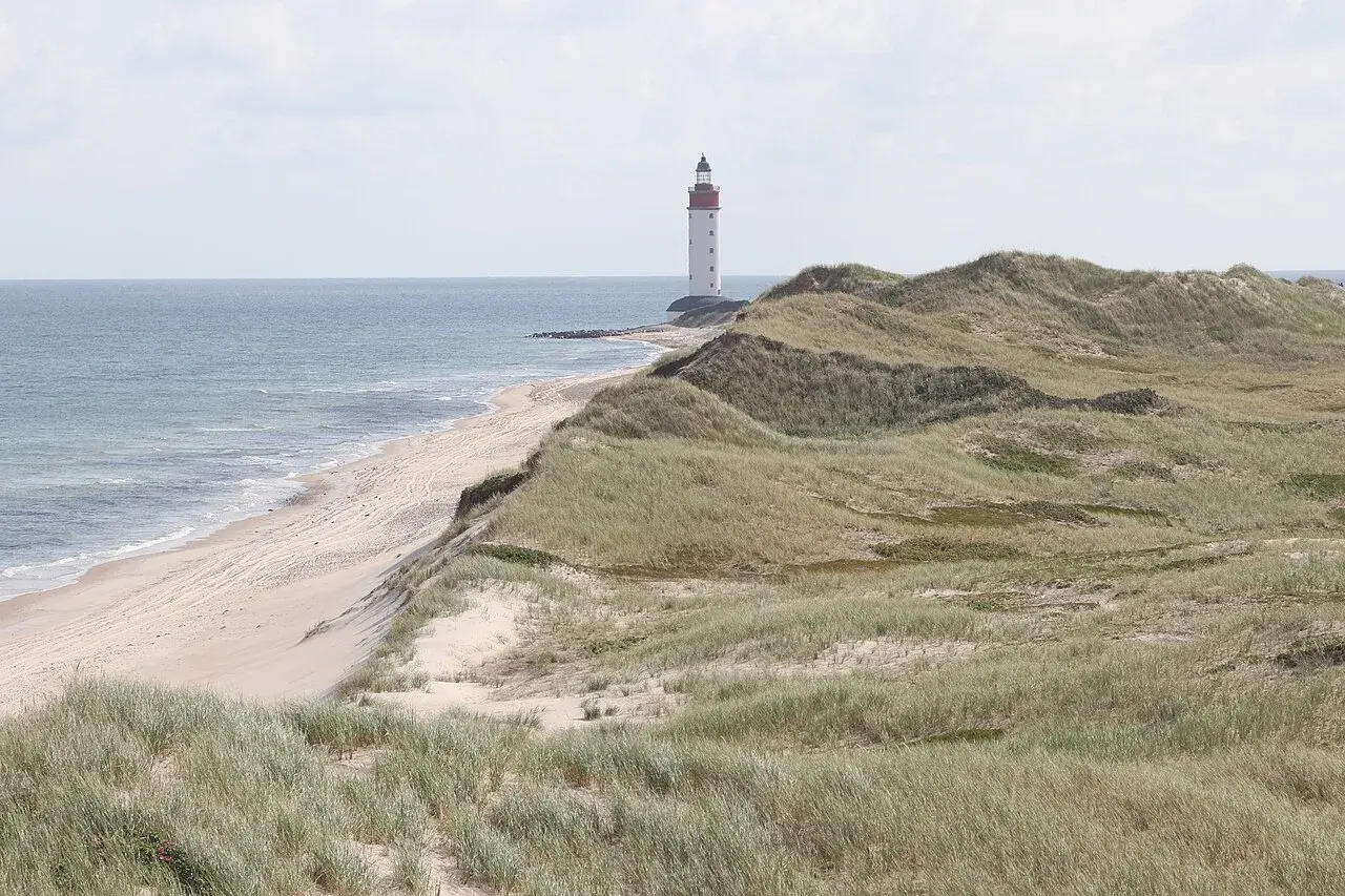 Udsigt over Anholt Nordstrand med fyret i baggrunden. Et kystnært motiv fra Danmark, registreret i databasen for fredede bygninger.