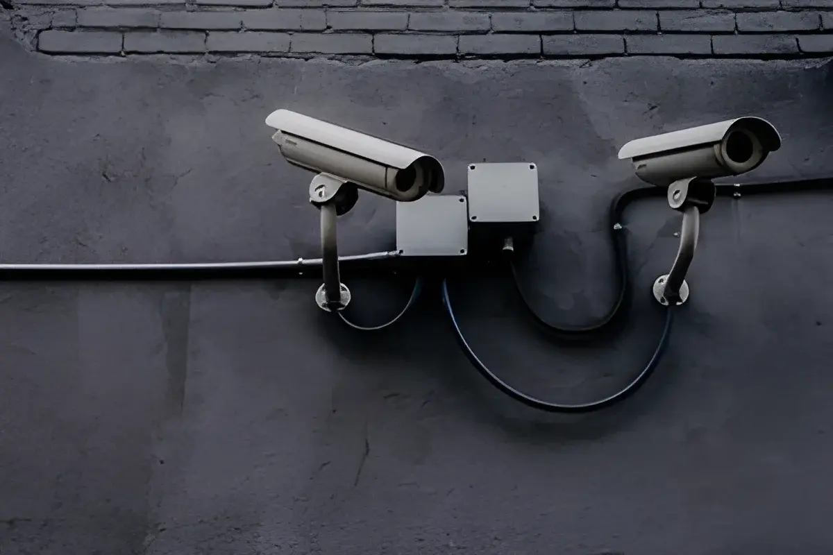 Two CCTV cameras on gray wall