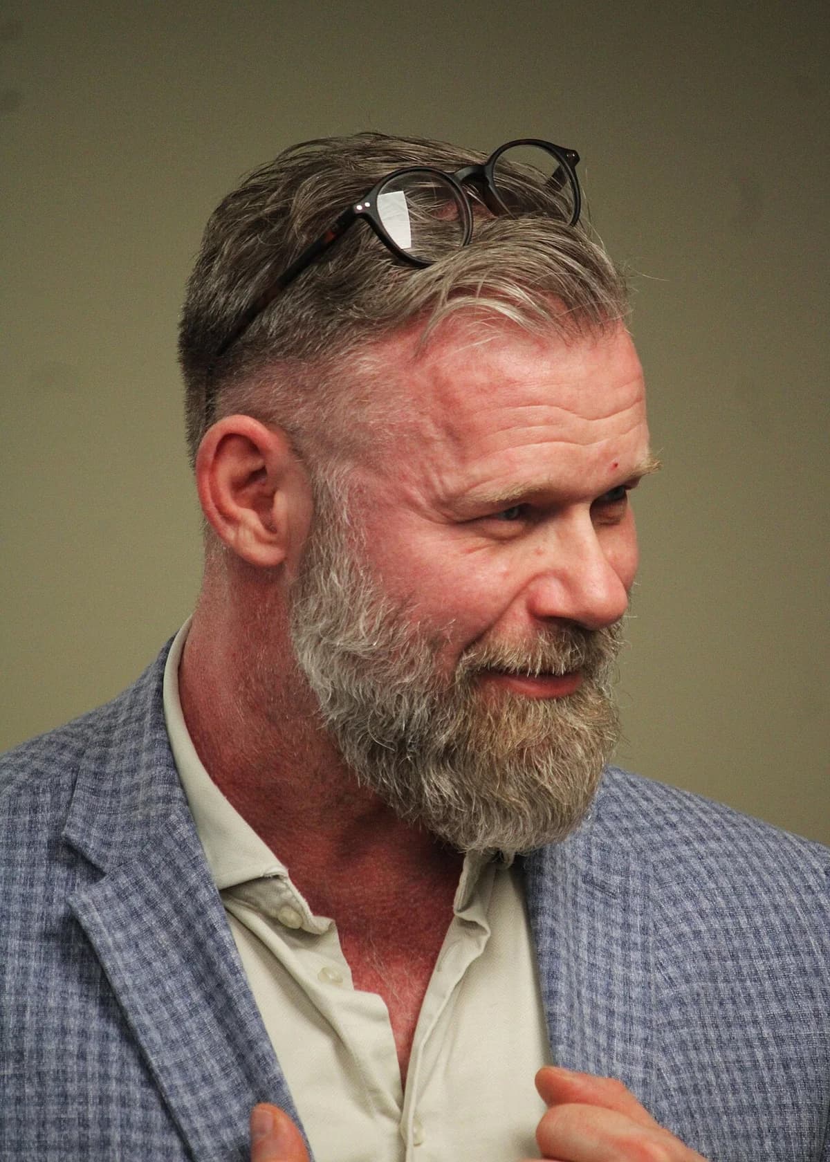 Close-up of Joachim B. Olsen speaking at a debate event.