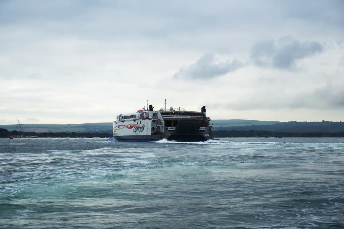 Large ferry sailing in Poole Harbour under cloudy sky