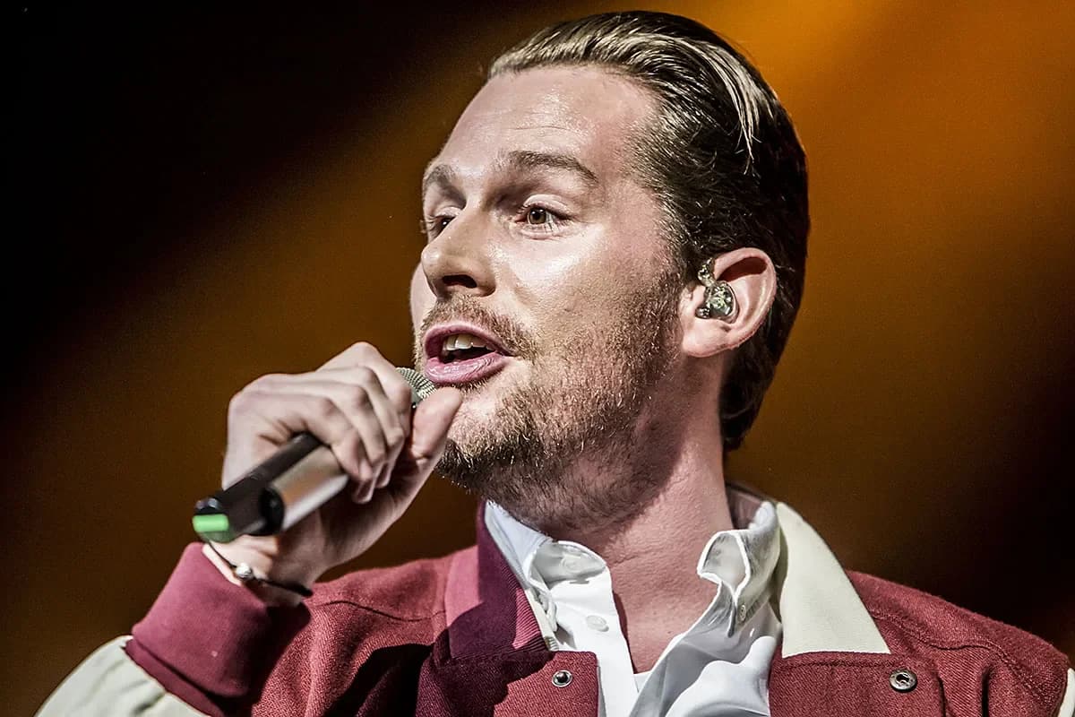 Male singer holding microphone during live performance