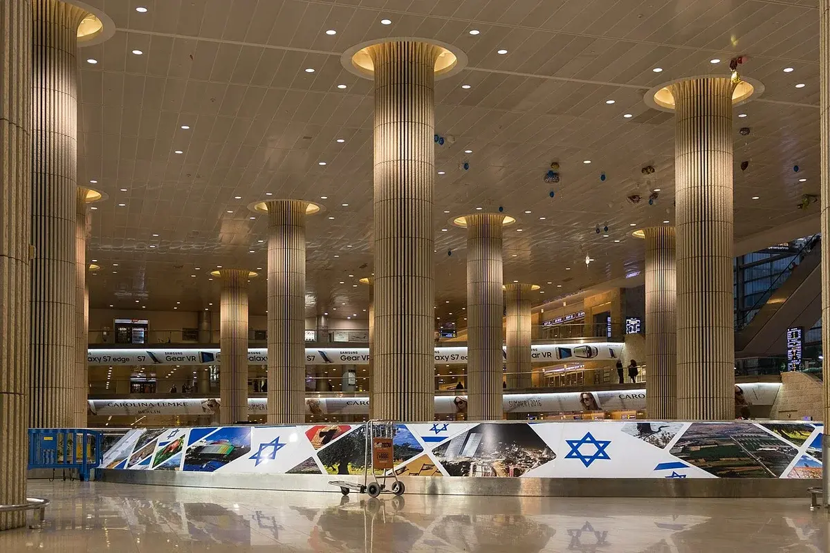 Interior of Ben Gurion International Airport with tall columns and a reflective floor.