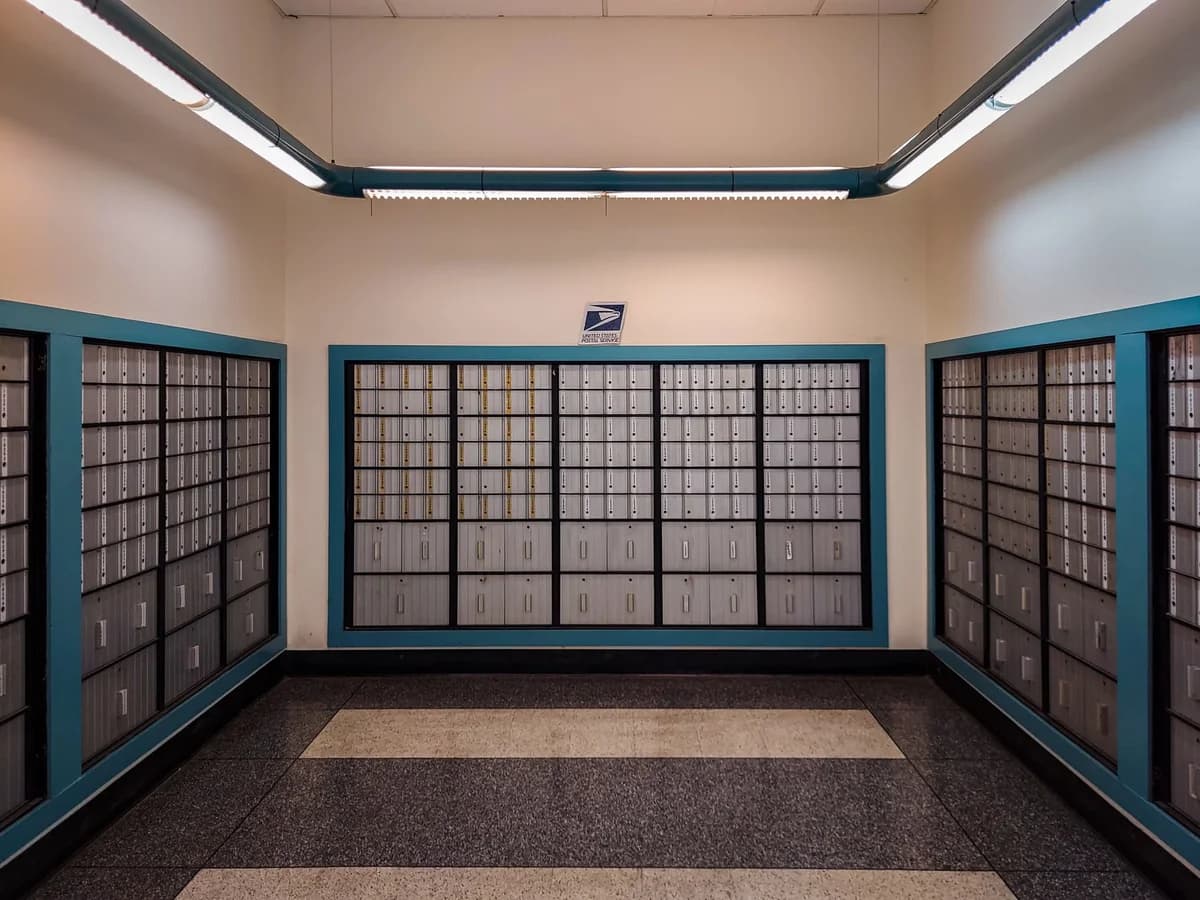 Rows of locked mailboxes inside a post office.