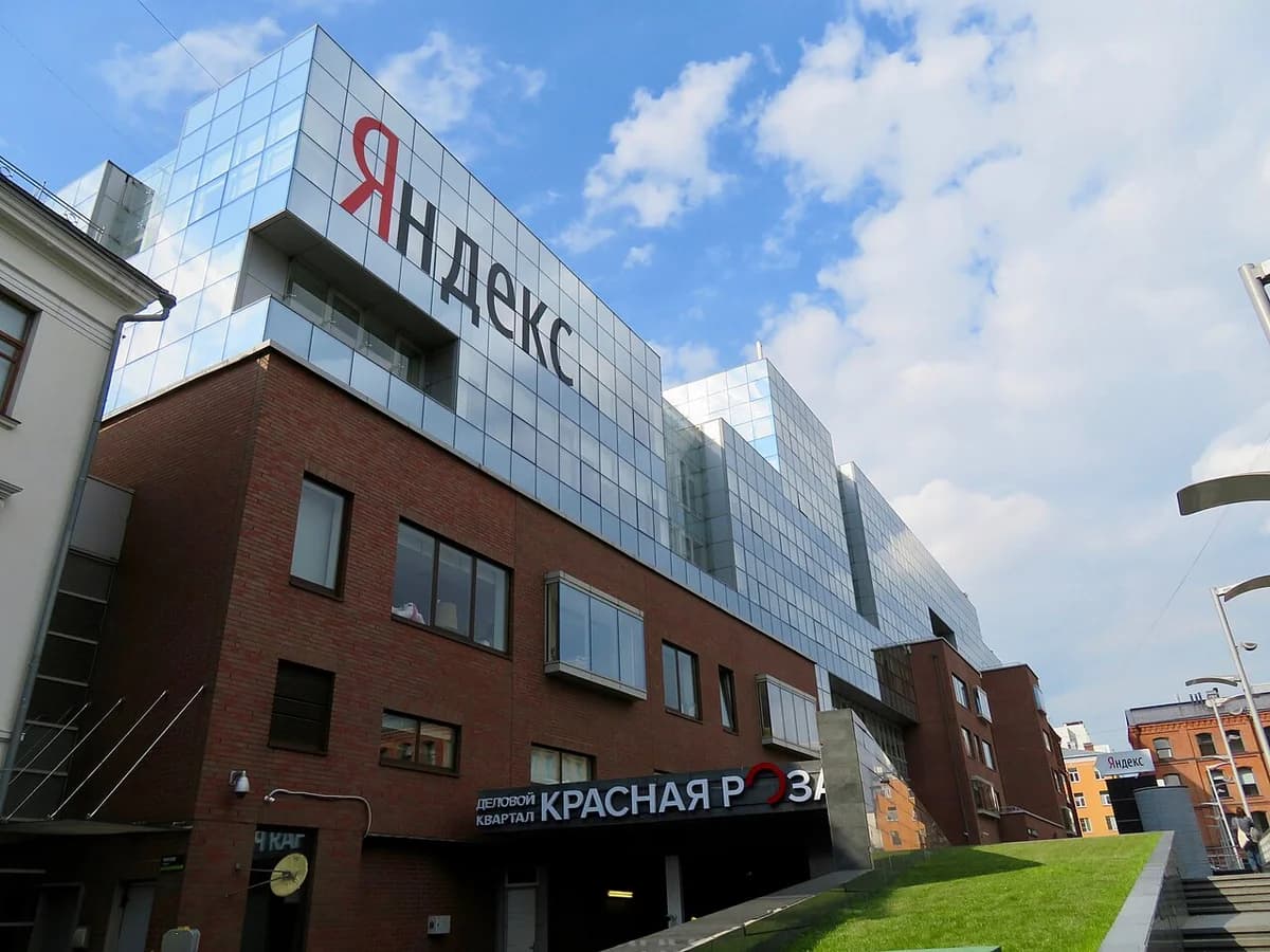 Yandex headquarters building in Moscow with a large logo on the facade.