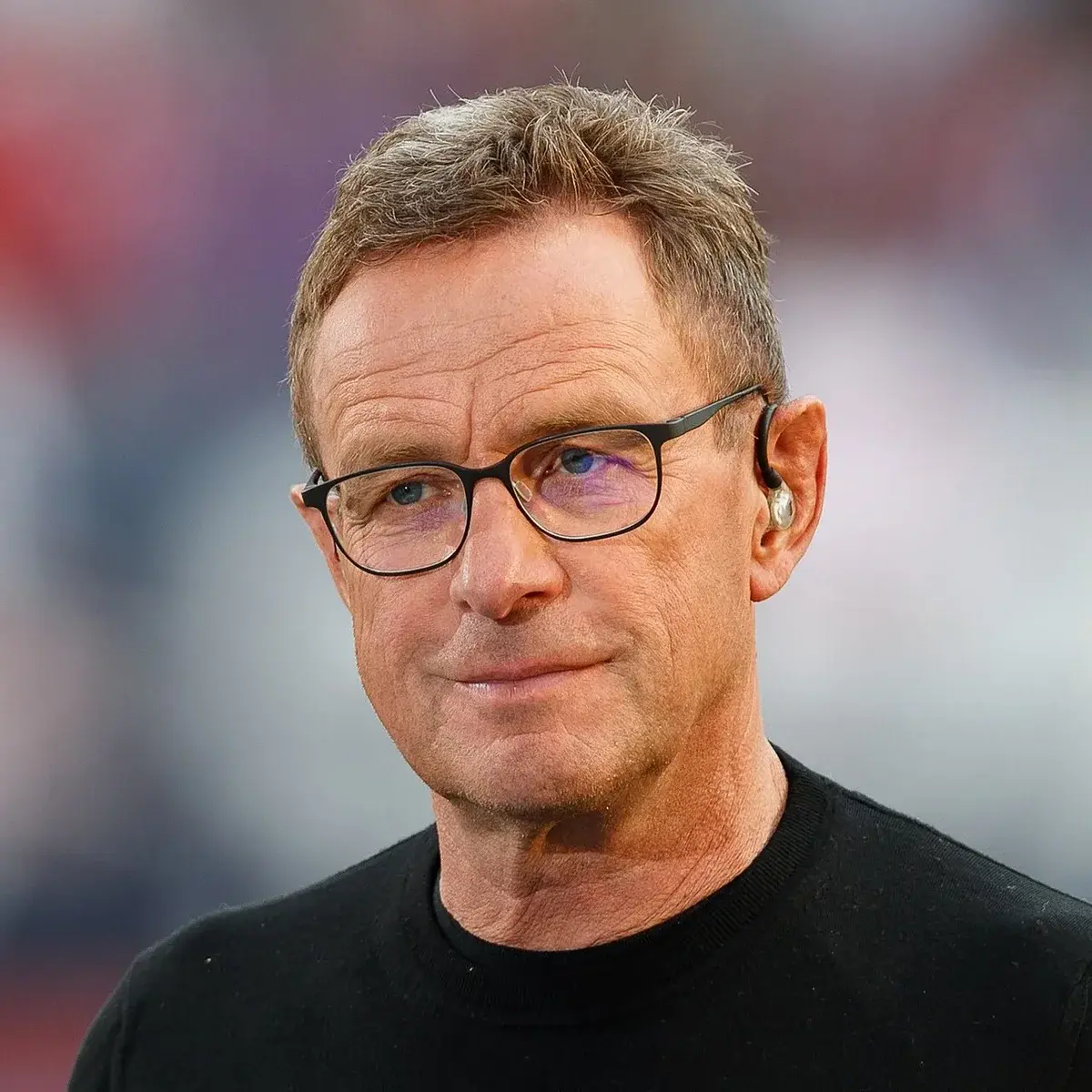 Portrait of Ralf Rangnick wearing glasses and a black shirt