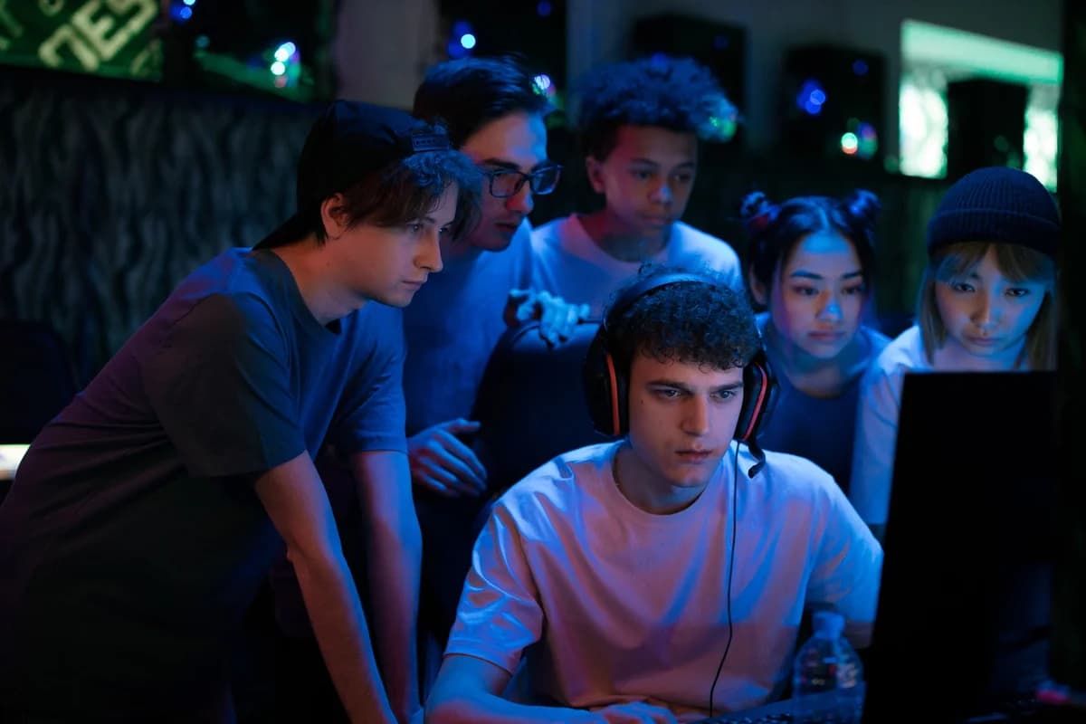 A diverse group of teenagers playing video games together indoors.