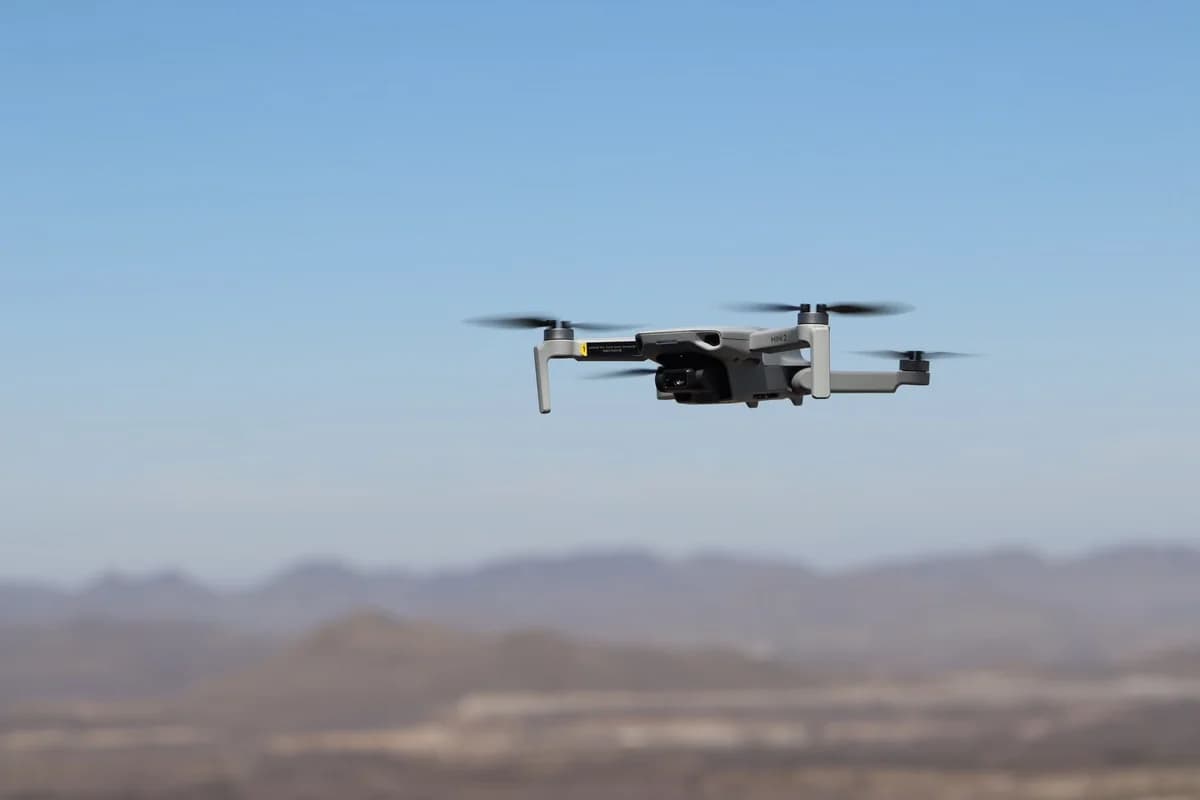 A drone flying over a desert landscape.