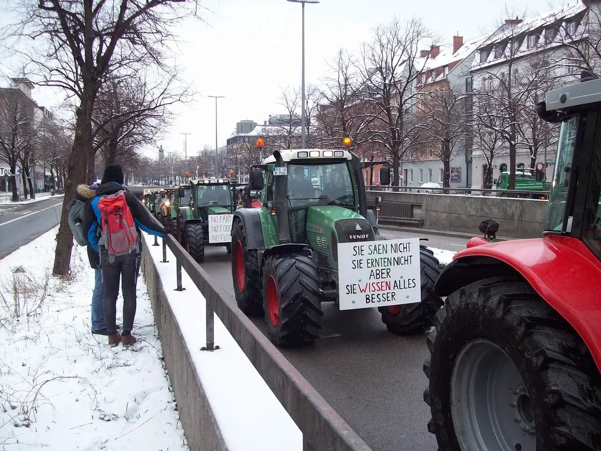 Farmers protesting in city with tractors on snowy street
