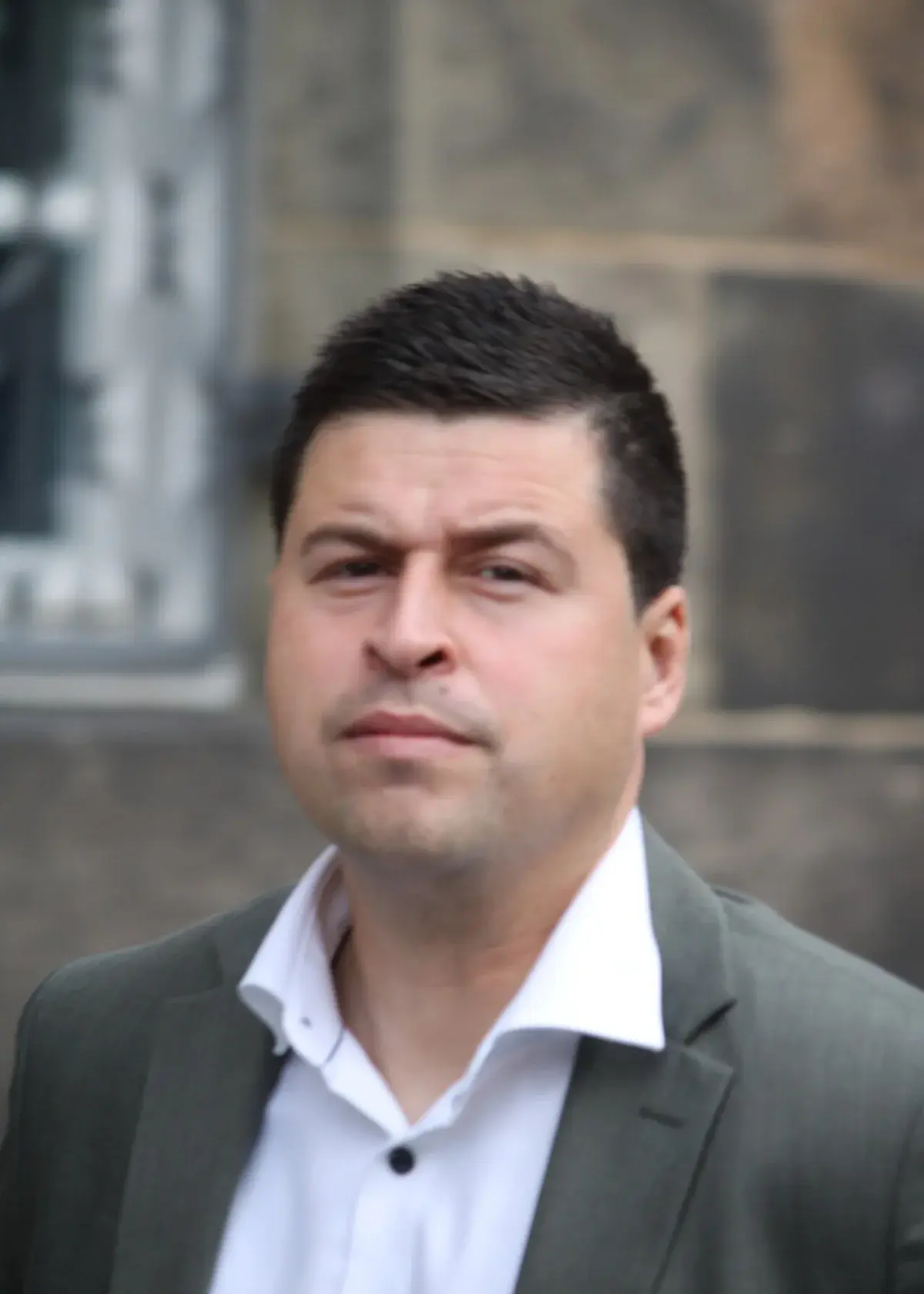 Portrait of Danish politician Mike Fonseca outdoors at Christiansborg.