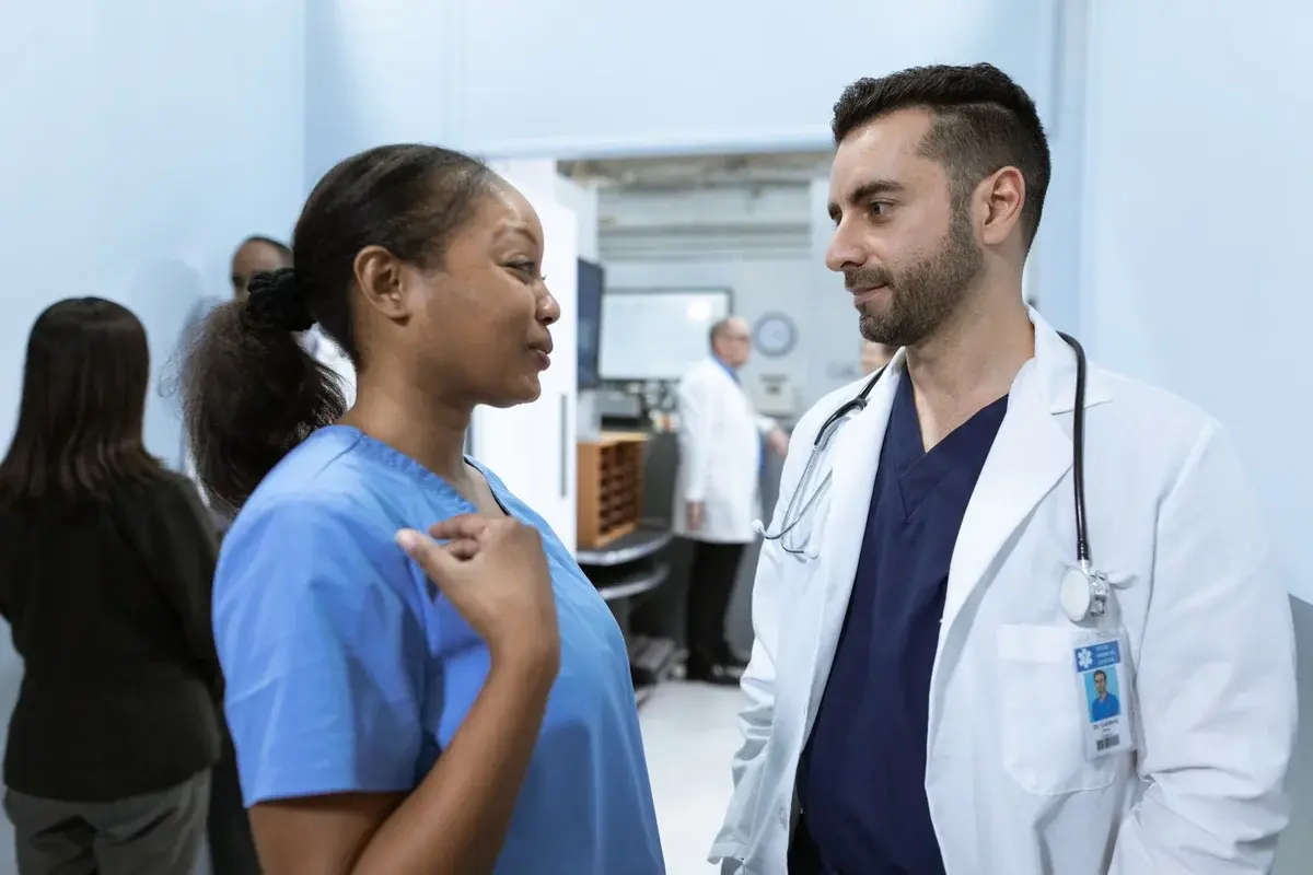 Doctors and nurses talking in a hospital hallway.