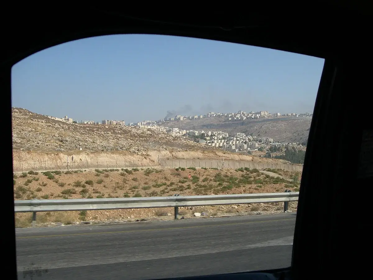 View from a taxi of Israeli settlements on hills in the West Bank.