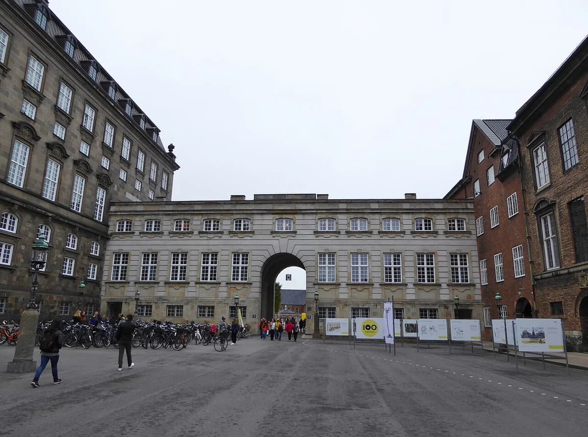 Courtyard of Rigsdagsgården with historic buildings and people walking in Copenhagen