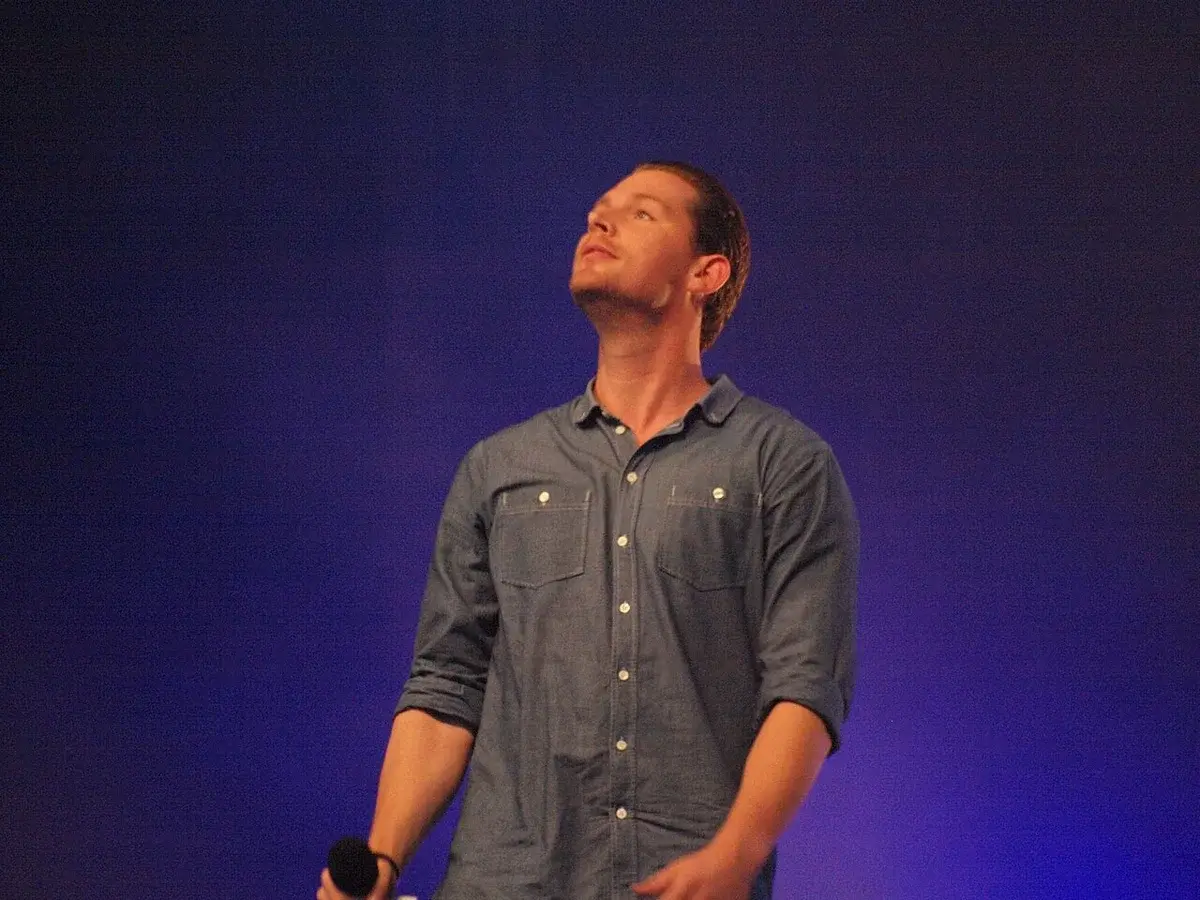 Close-up portrait of Danish singer Rasmus Seebach on stage.