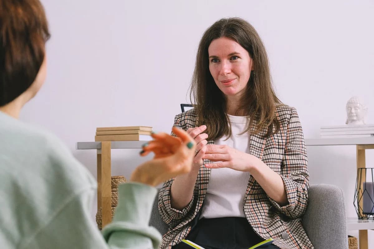 A counselor talking with a woman during a session.