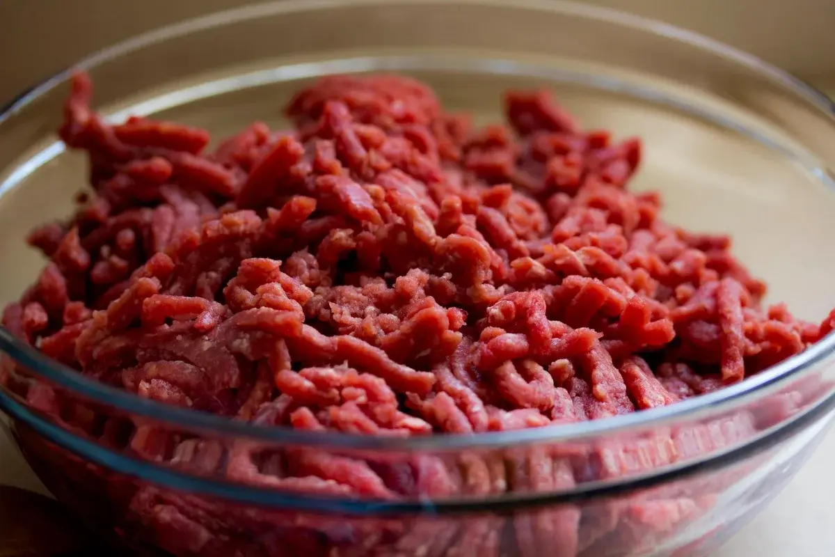 Close-up of ground beef in a glass bowl.
