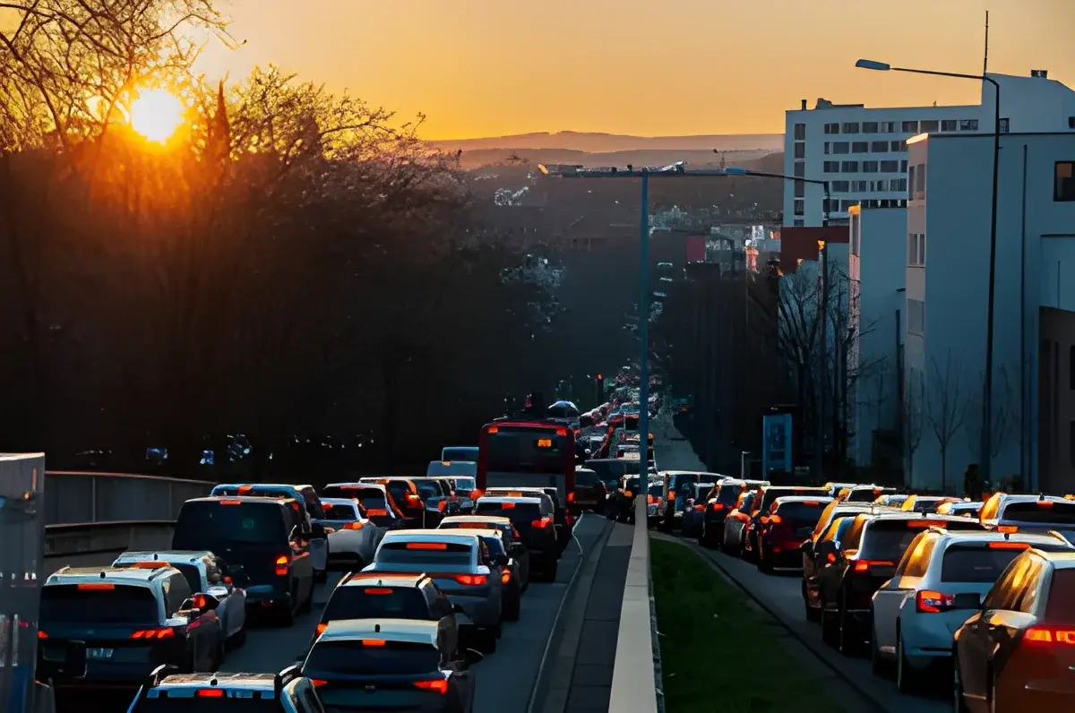 Heavy traffic on city road at sunset