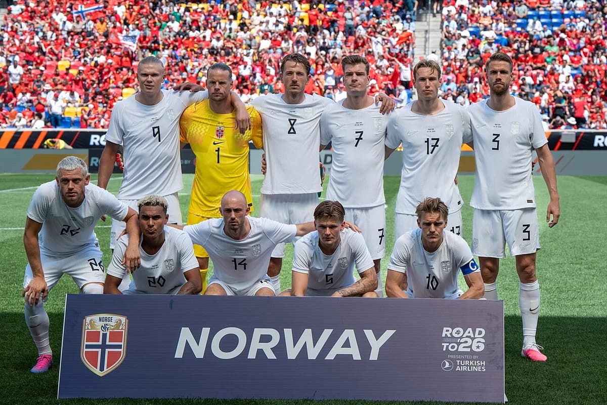 Norway national football team posing for a pre-match photo on the field.
