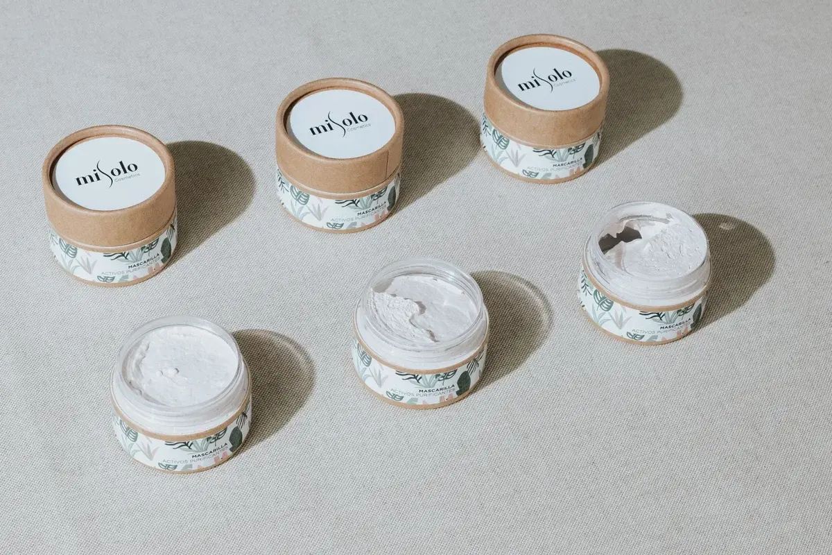 Overhead view of skincare cream jars in sustainable packaging.