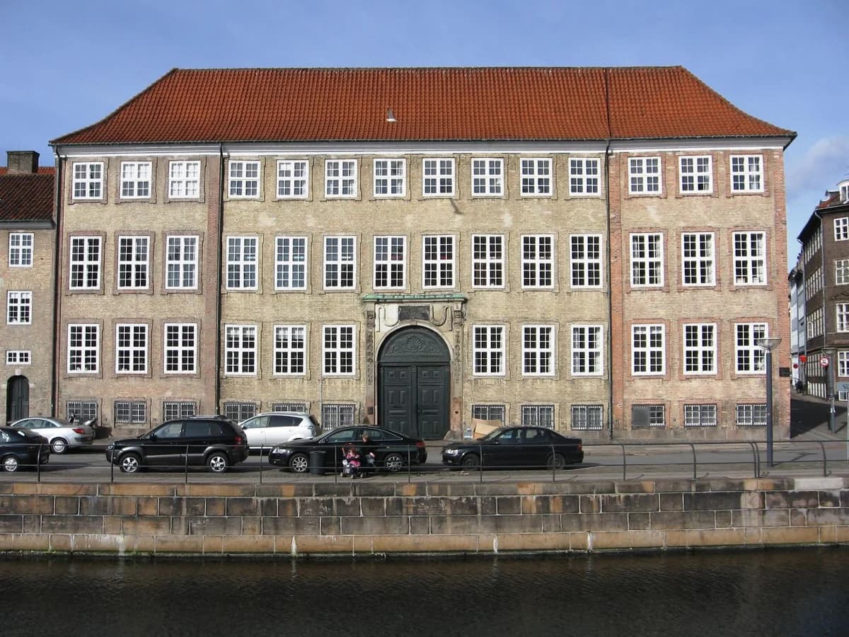 A historic government building beside a canal in Copenhagen.