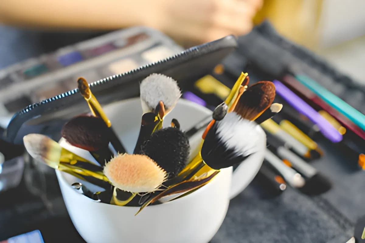 Various makeup brushes in a white container