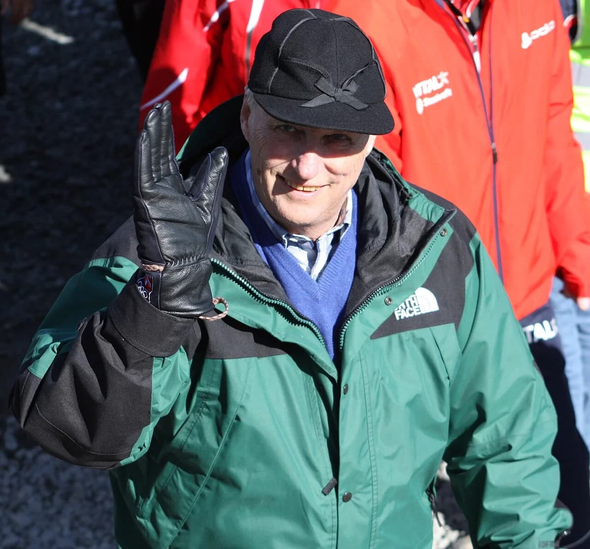 Man in winter jacket waving