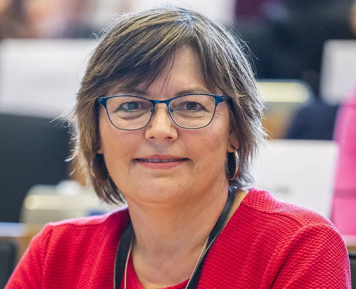 Portrait of MEP Marianne Vind at a parliamentary committee meeting.