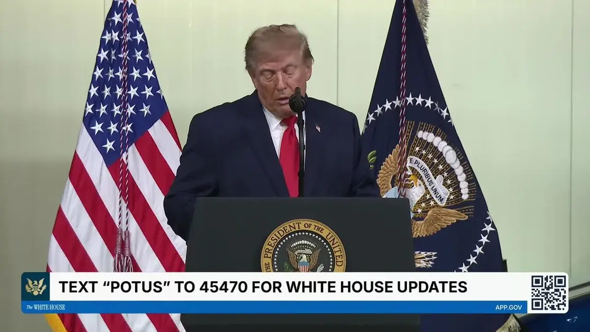 Donald Trump speaking at a podium with U.S. and presidential flags behind him.
