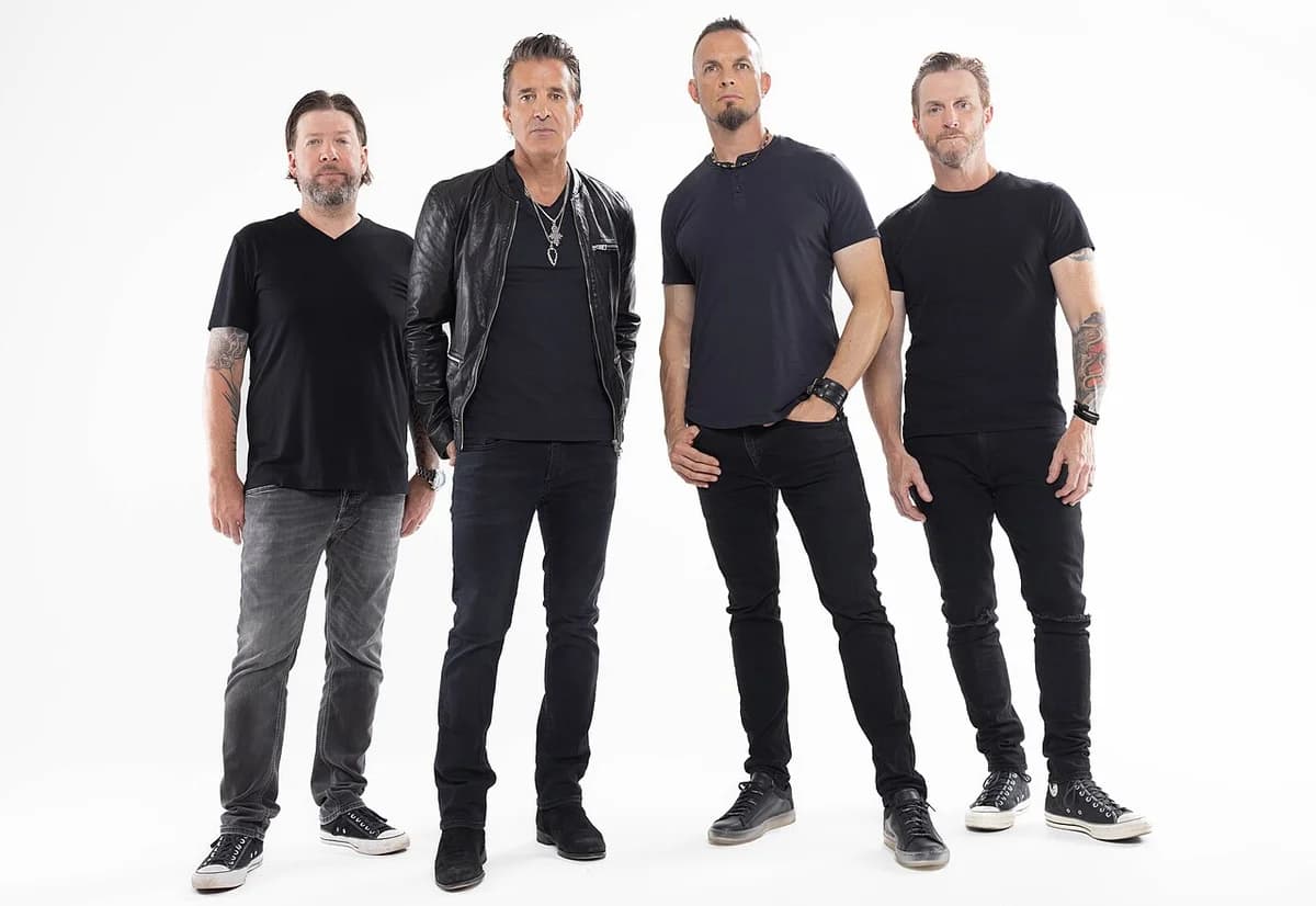 The rock band Creed posing together in a studio on a white background.