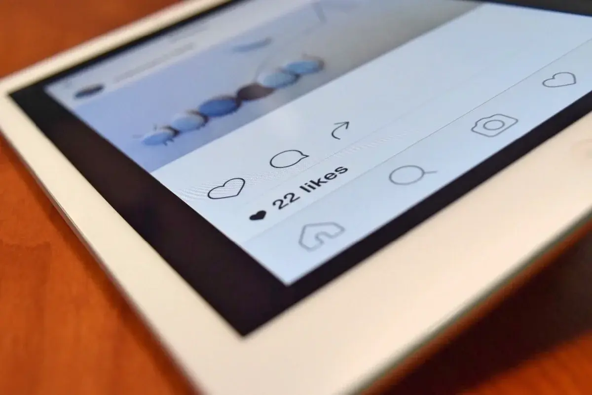 Tablet screen showing social media app with 22 likes