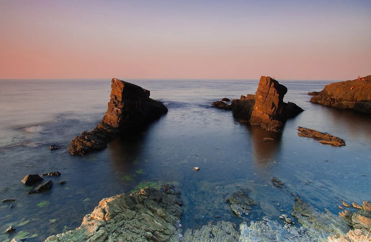 Sunset over rocky sea stacks on Bulgaria's Black Sea coast.