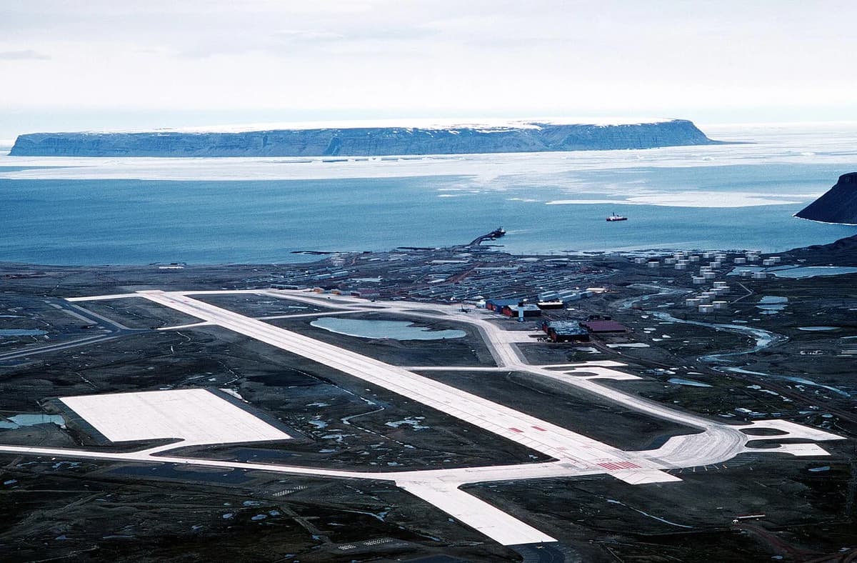 Aerial photo of Thule Air Base in Greenland with runways and Arctic coastline.