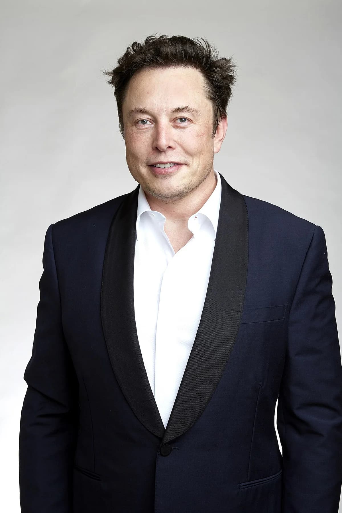 Portrait of Elon Musk in a tuxedo jacket.
