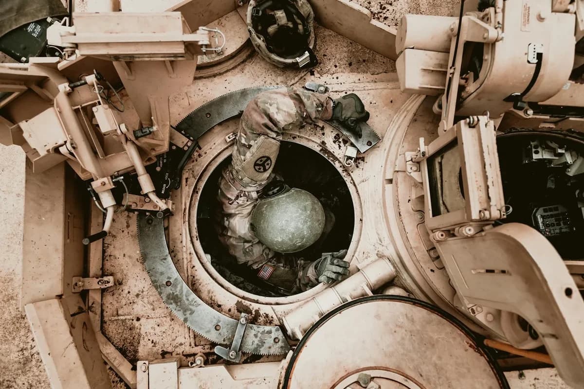 Soldier entering armored military vehicle