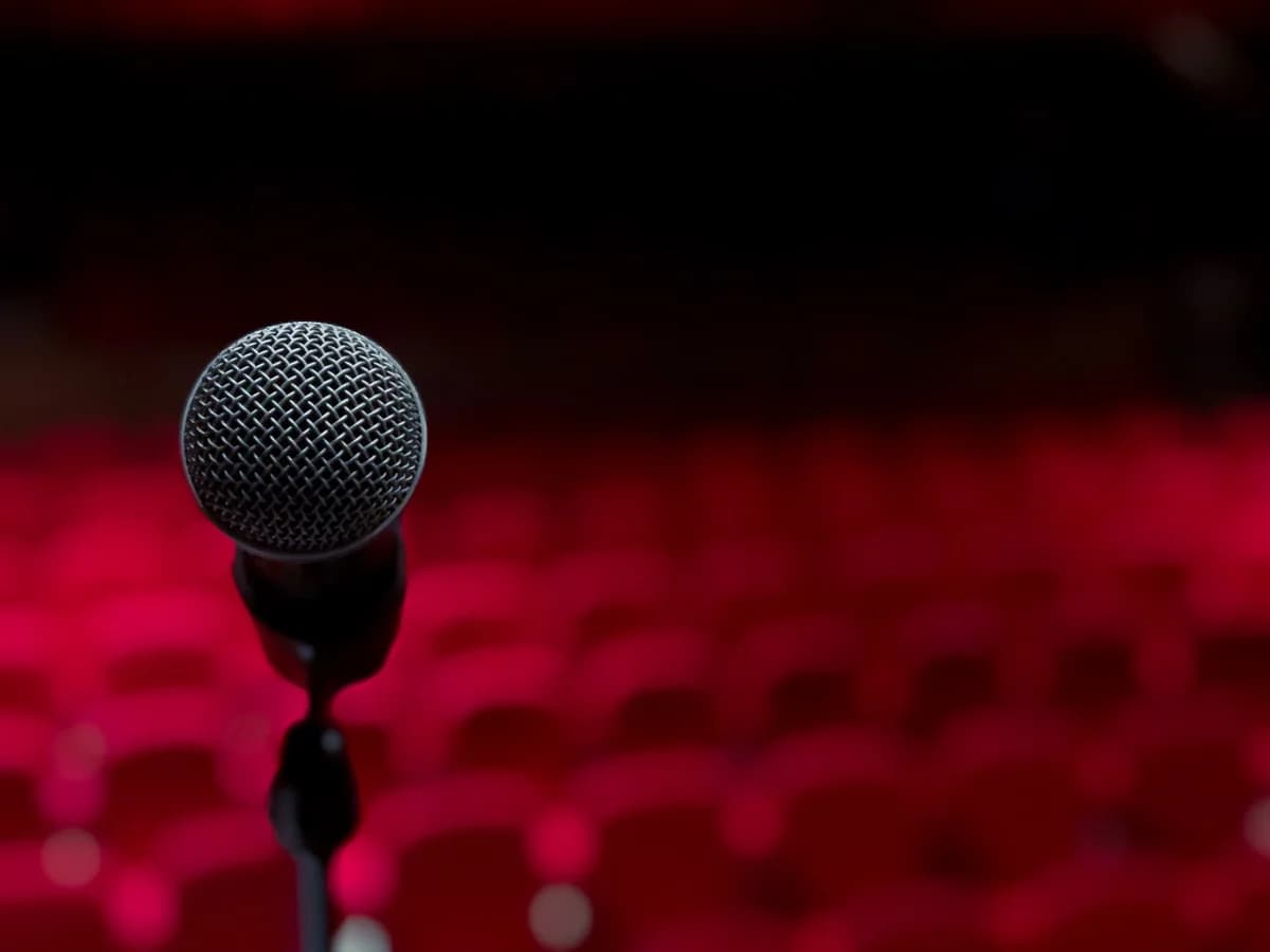 Microphone on stage with blurred red seats behind