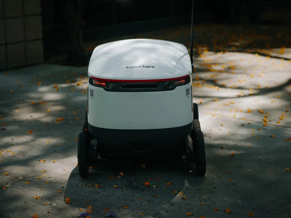 A small autonomous delivery robot on a city street.
