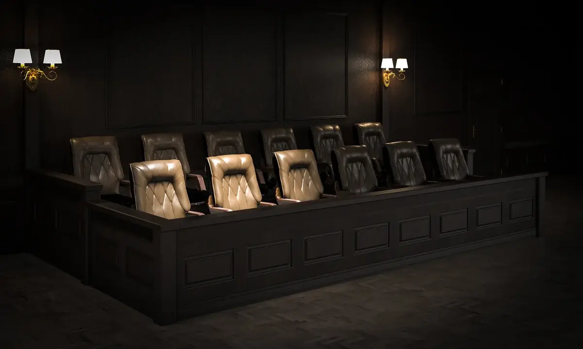 Empty jury box in a dark courtroom