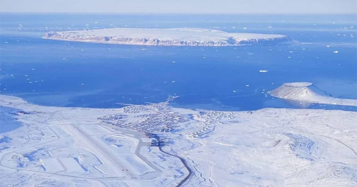 Aerial view of a snowy air base on the coast of Greenland.