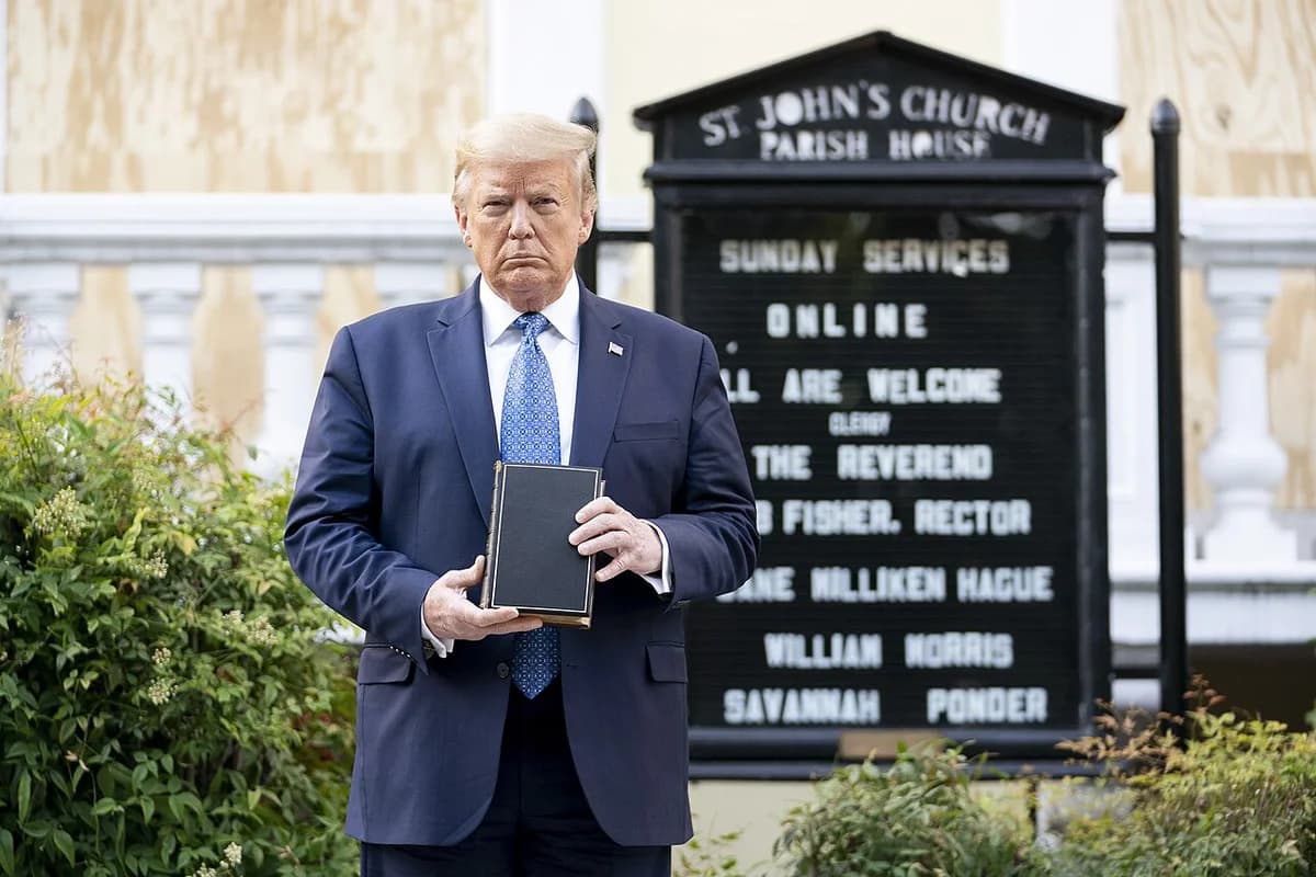 Donald Trump stands holding a Bible in front of St. John's Episcopal Church.