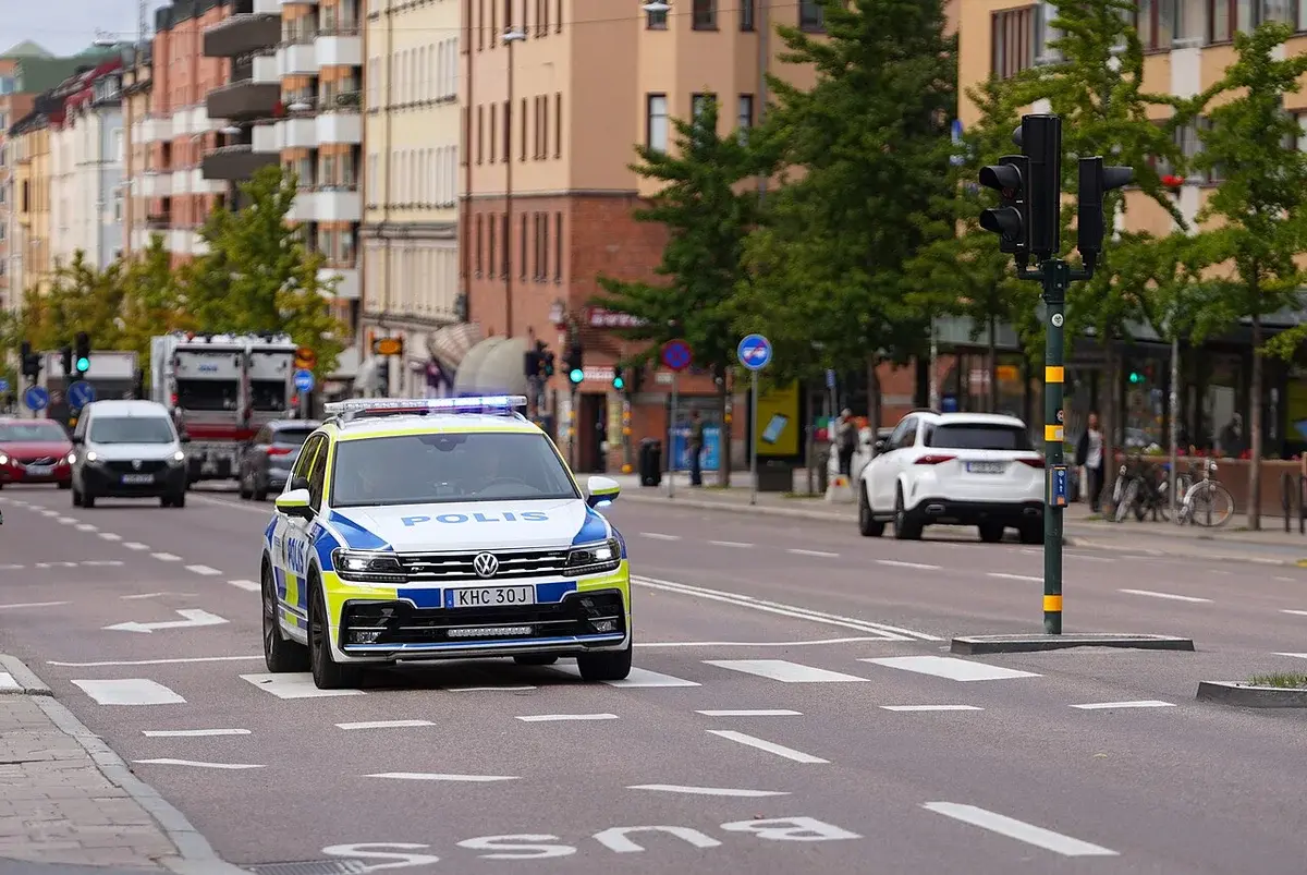Swedish police car with blue lights on city street