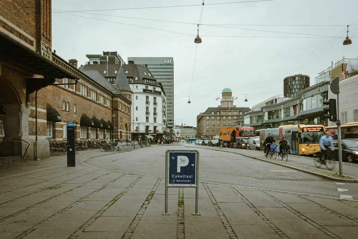Copenhagen street with historic buildings, bicycles, and light traffic.