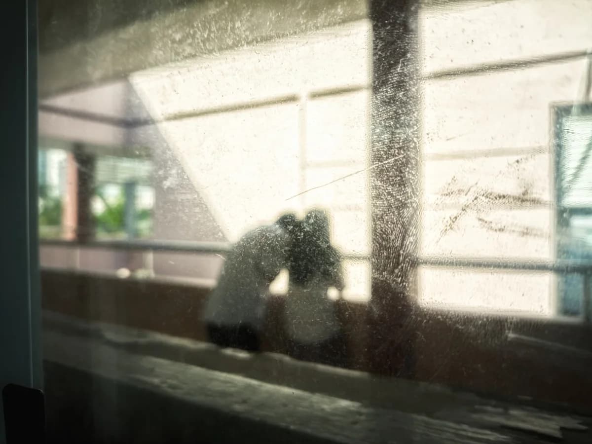Blurred silhouette of a couple by a window.