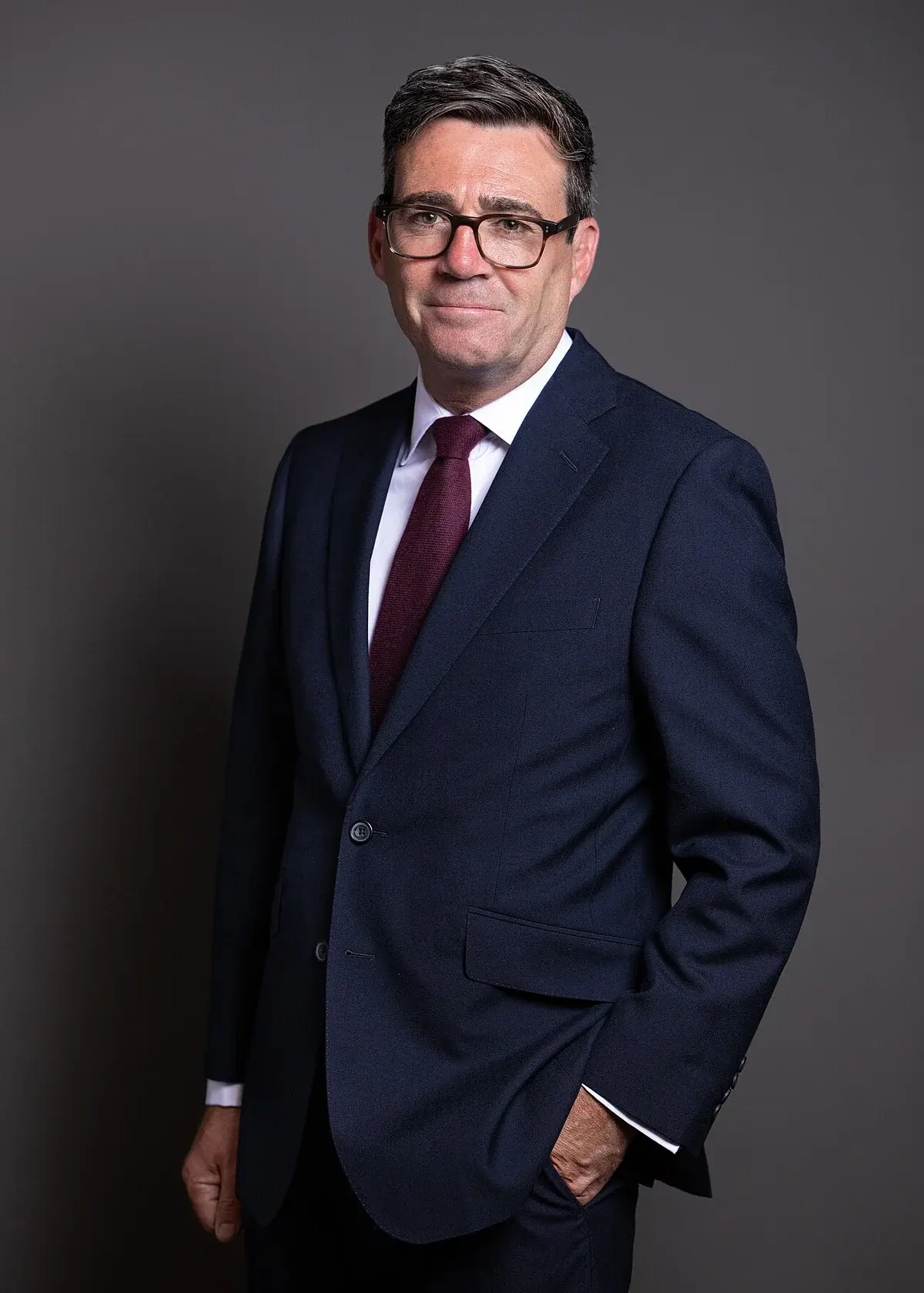 Formal portrait of Andy Burnham in a suit and tie.