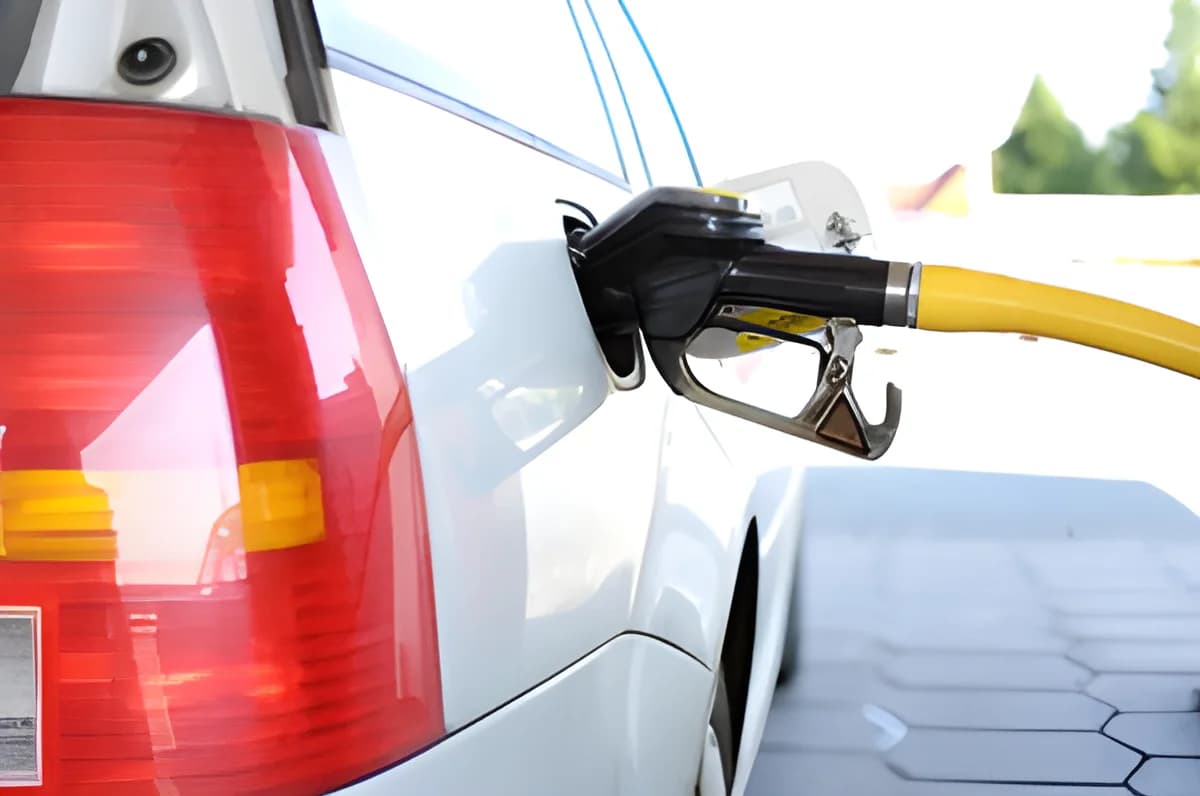 White car being refueled at gas station