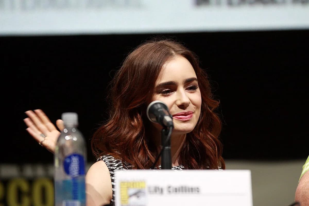 Lily Collins speaking at a microphone at San Diego Comic-Con 2013.