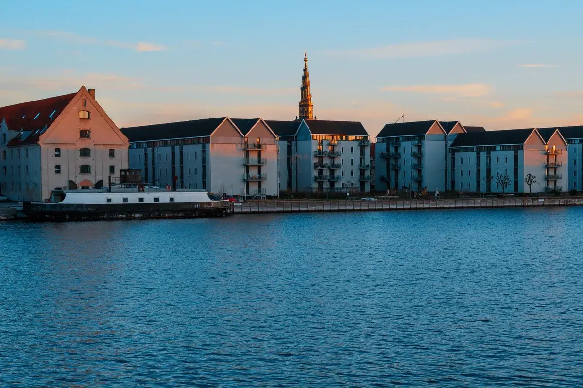 Residential buildings on the Copenhagen waterfront at sunset.